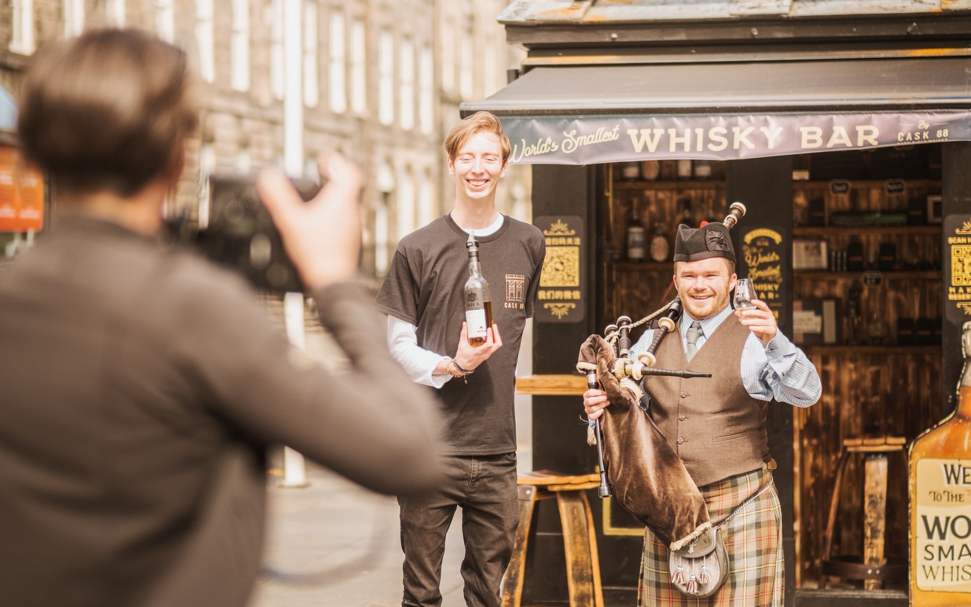Bartender Mark Young with bagpiper Grant Grant MacLeod, outside the World's Smallest Whisky Bar